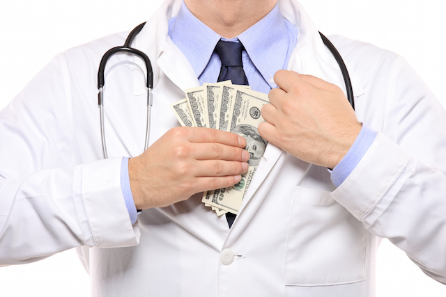 A doctor putting money in his pocket isolated on white background